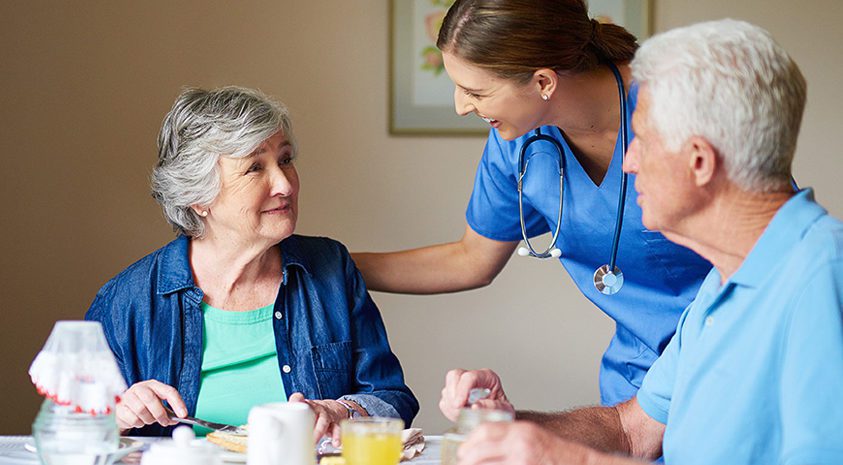 assisted care caregiver reassuring senior
