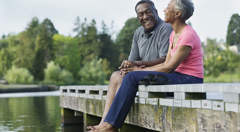 Elderly Couple Sitting on Pier