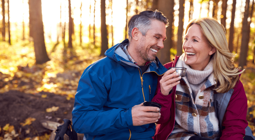 happy couple hiking in woods