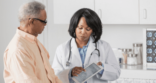 Women doctor reviewing results on iPad with male patient