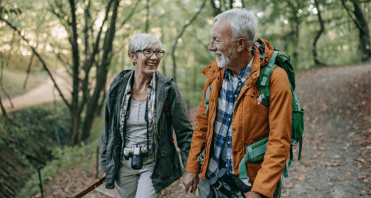 Senior couple hiking and traveling in woods together