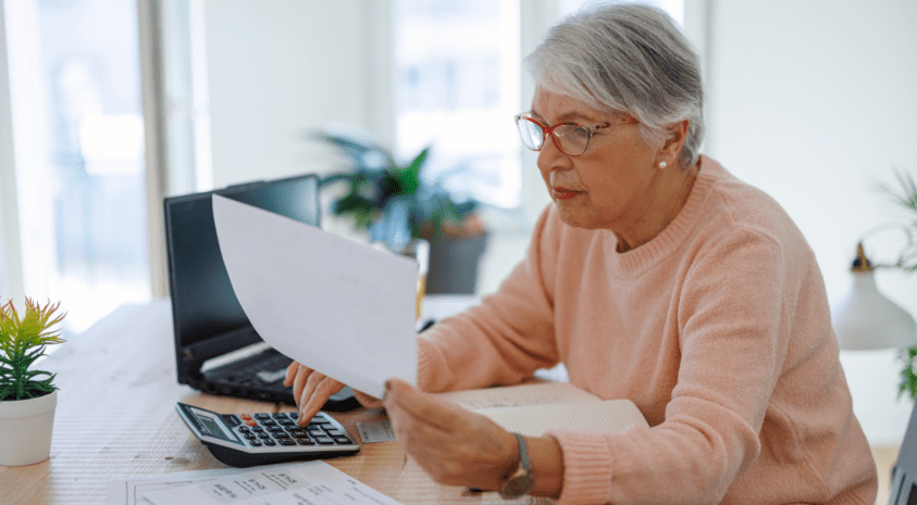 Senior woman reviewing her finances at laptop