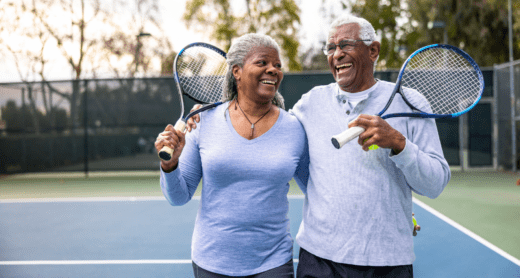 Retirement couple playing tennis together
