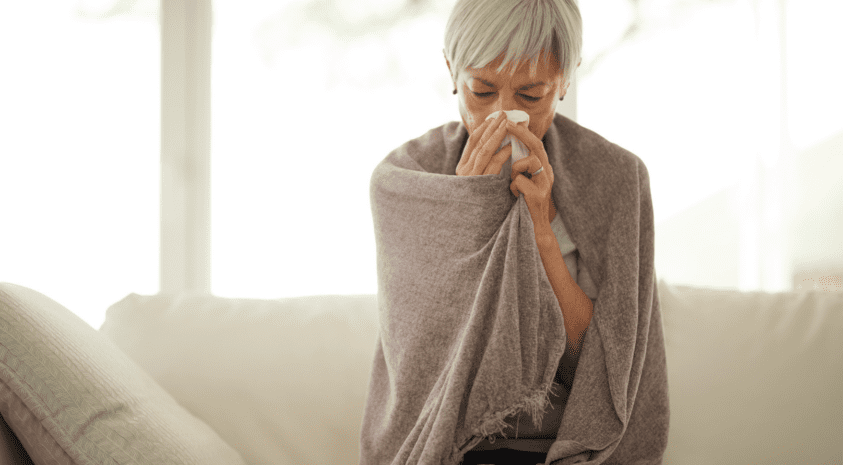 Women with sinus cold on couch