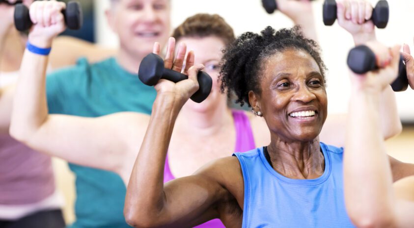 Senior woman working out at gym
