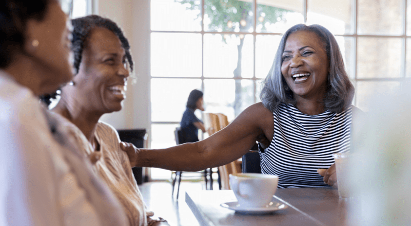 Women laughing at cafe