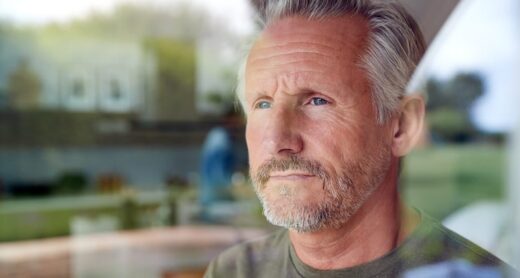 Aging man looks thoughtful as he ponders his financial circumstances.