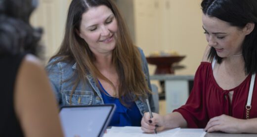 A young woman in her 20s buying her first home with the help of her mother and a real estate agent.