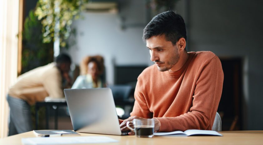 Man on his laptop looking serious.