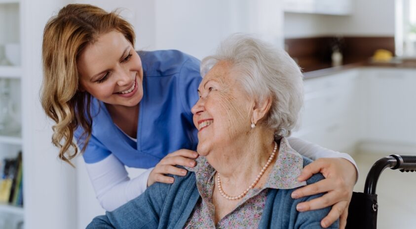 Nurse and senior client in a wheelchair.