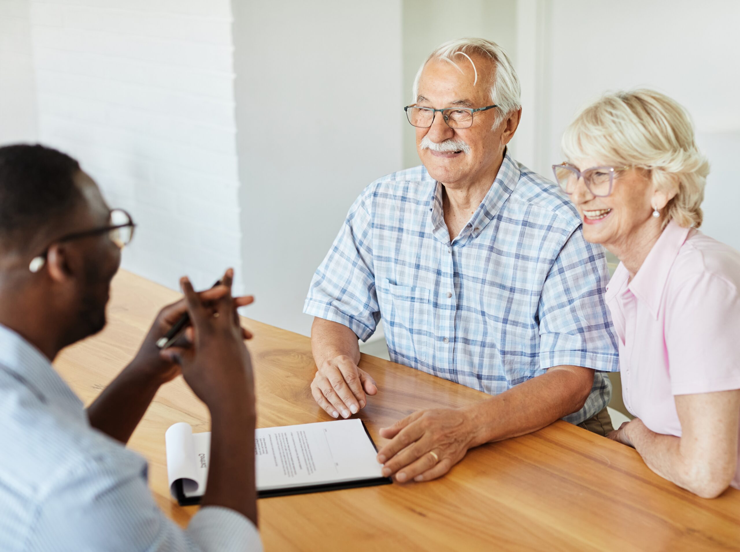 Older couple sitting at a table discussing LTC planning.