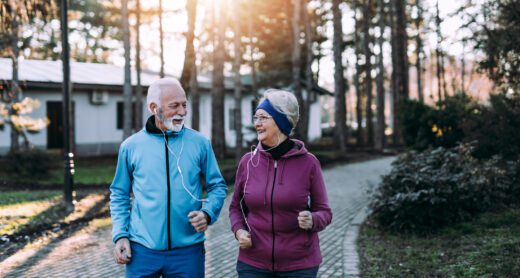 Retired couple enjoys exercising and jogging outdoors on a beautiful sunny day.