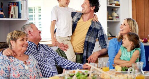 Multi generational family enjoying a meal together at home.