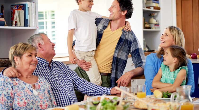 Multi generational family enjoying a meal together at home.