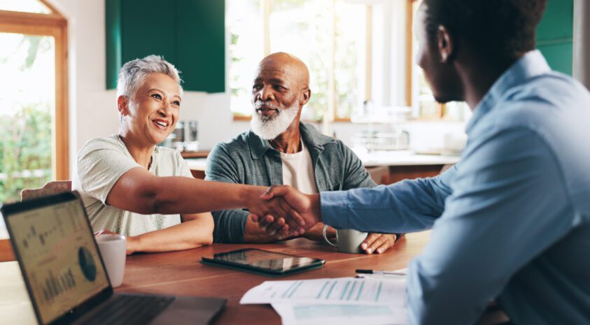A senior couple meets with a financial professional to discuss their estate plan and estate taxes.