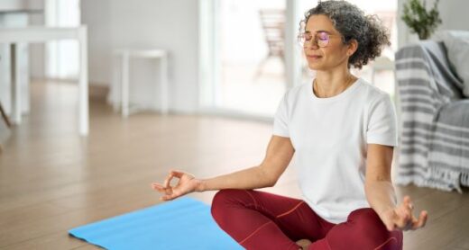 Woman meditating on a yoga mat.