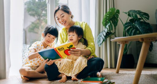 A mother reads a book to her children.