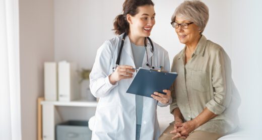 A senior woman talks to her doctor.
