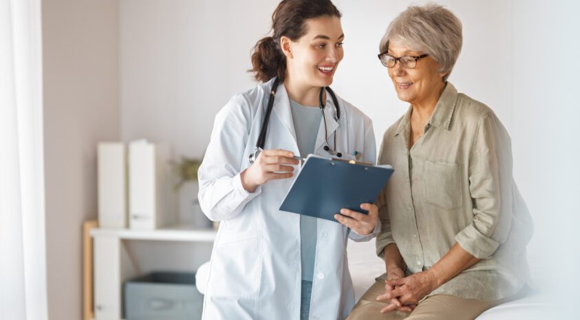 A senior woman talks to her doctor.