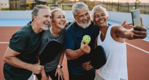 A group of retirees takes a selfie after a game of pickleball.