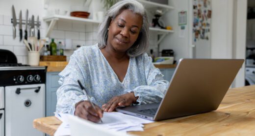 A retired woman reviews annuity payout options on her home computer.