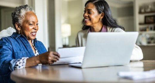 A woman helps her senior mother manage her Health Savings Account (HSA) and pay medical bills.
