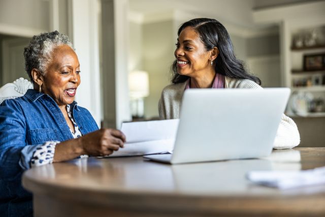 A woman helps her senior mother manage her Health Savings Account (HSA) and pay medical bills.