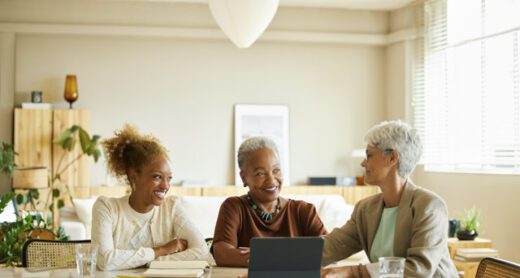 A retired woman and her adult daughter have a conversation with their financial advisor.