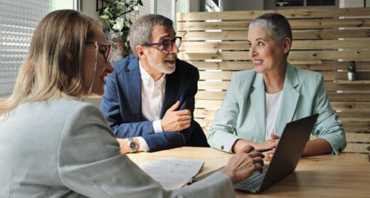 Retired couple talks with financial professional about life insurance.