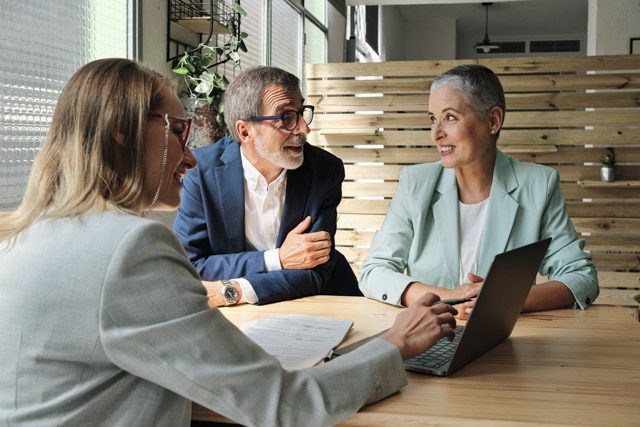 Retired couple talks with financial professional about life insurance.